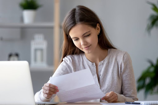 A woman reading a labor law compliance notice.